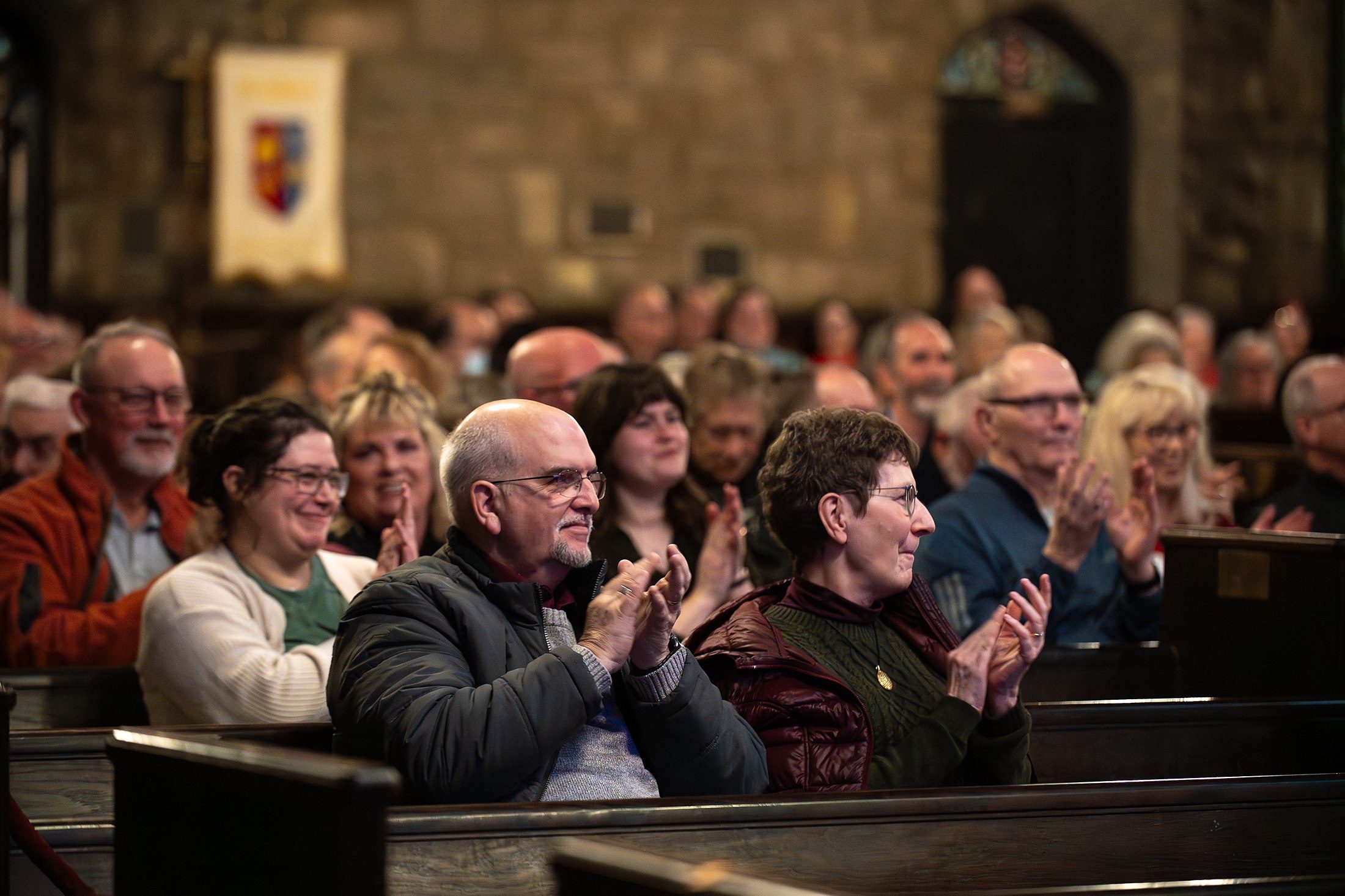 Audience members applauding at close range