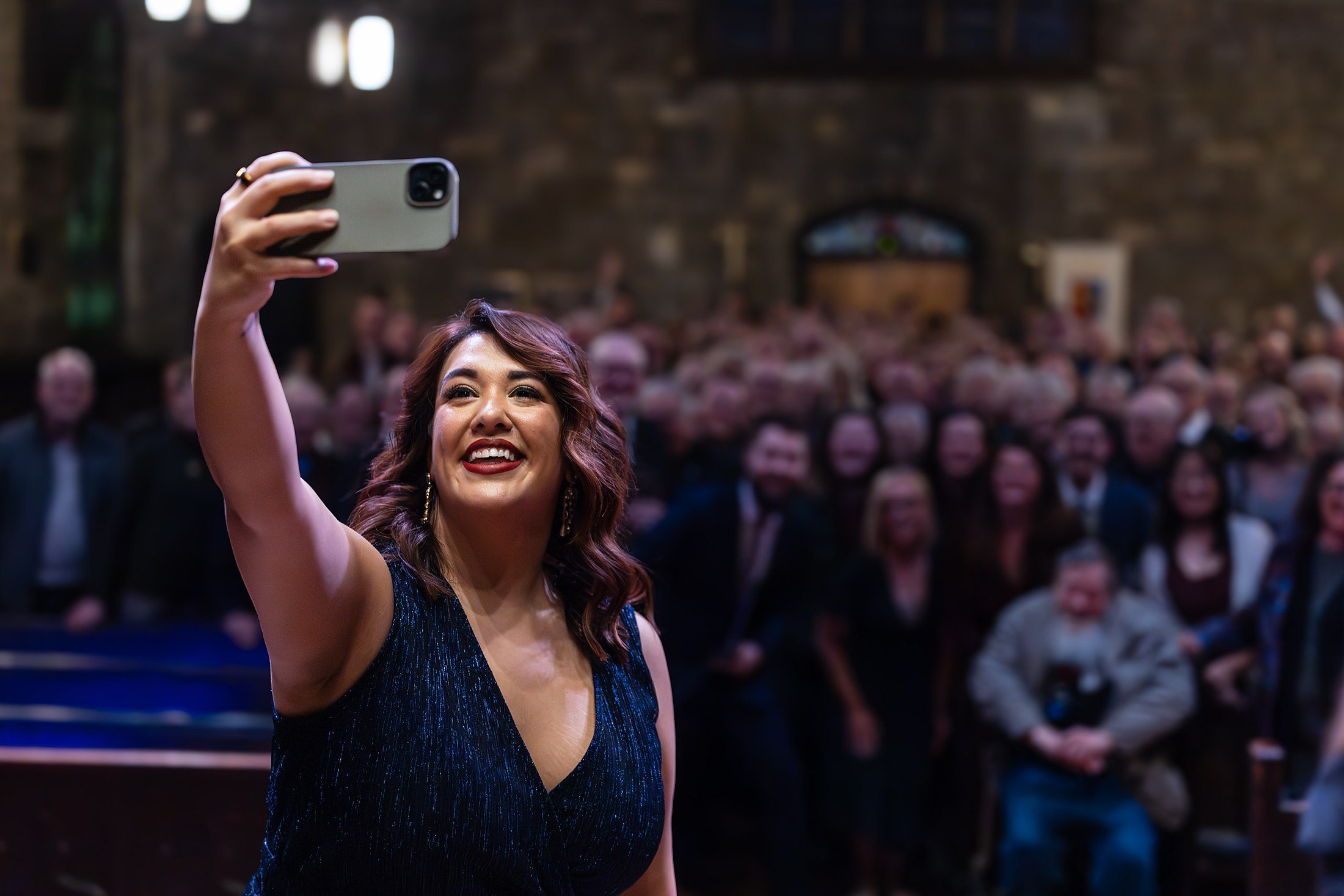 An Astra Ensemble singer photographing the audience after a concert